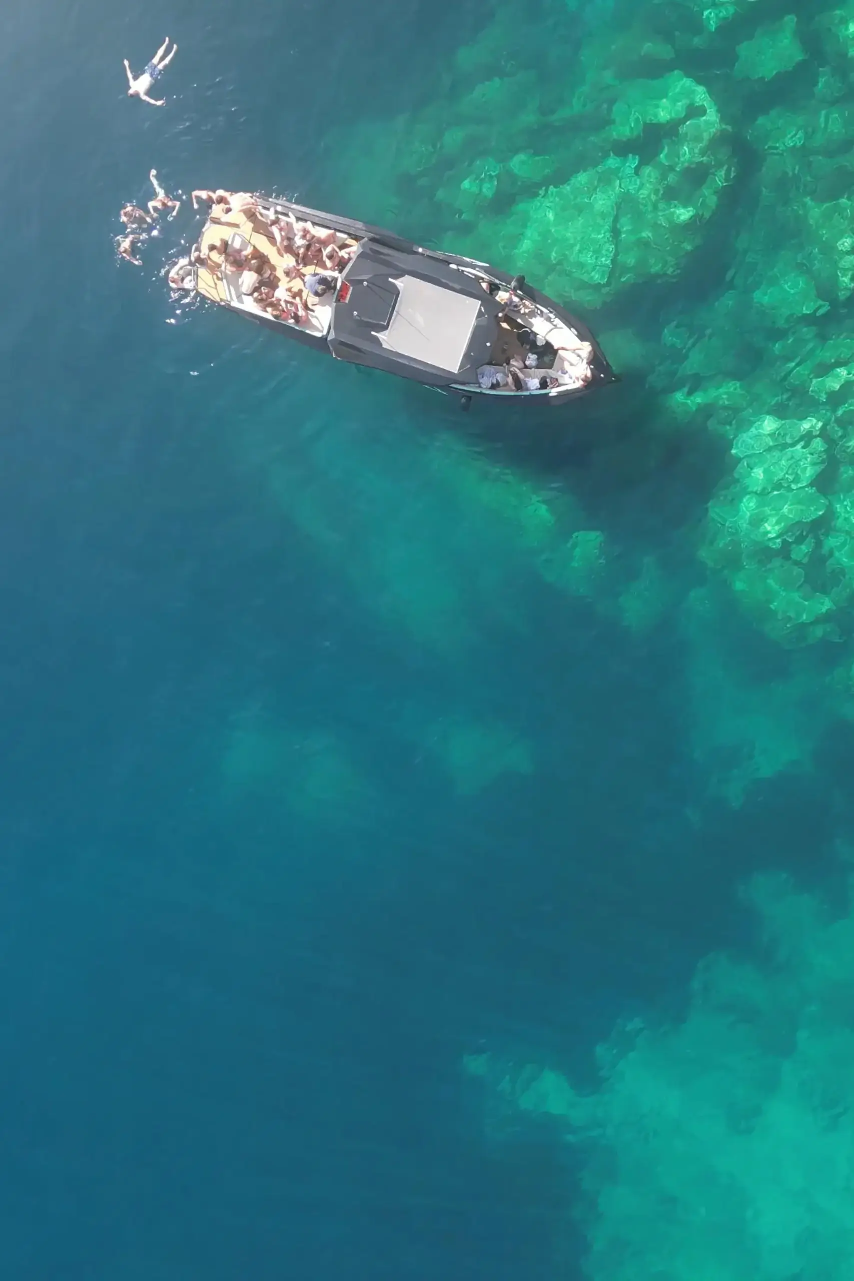 Aerial boart trip and party on water.