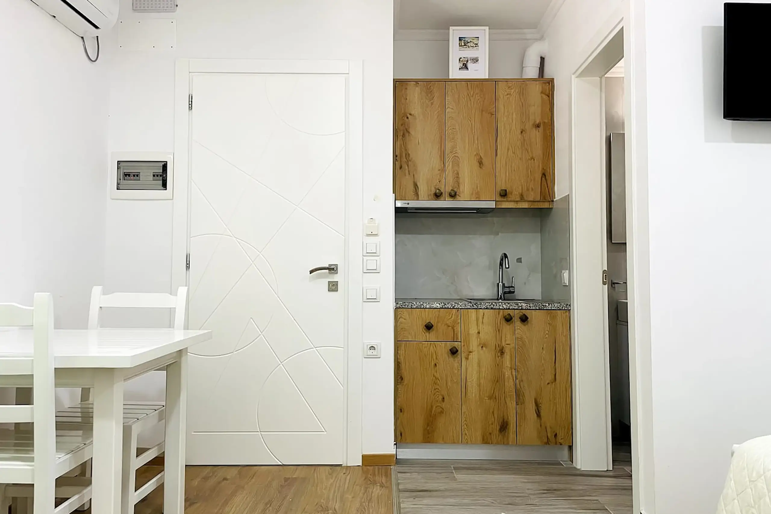 View of the kitchinette and entrance of the room.